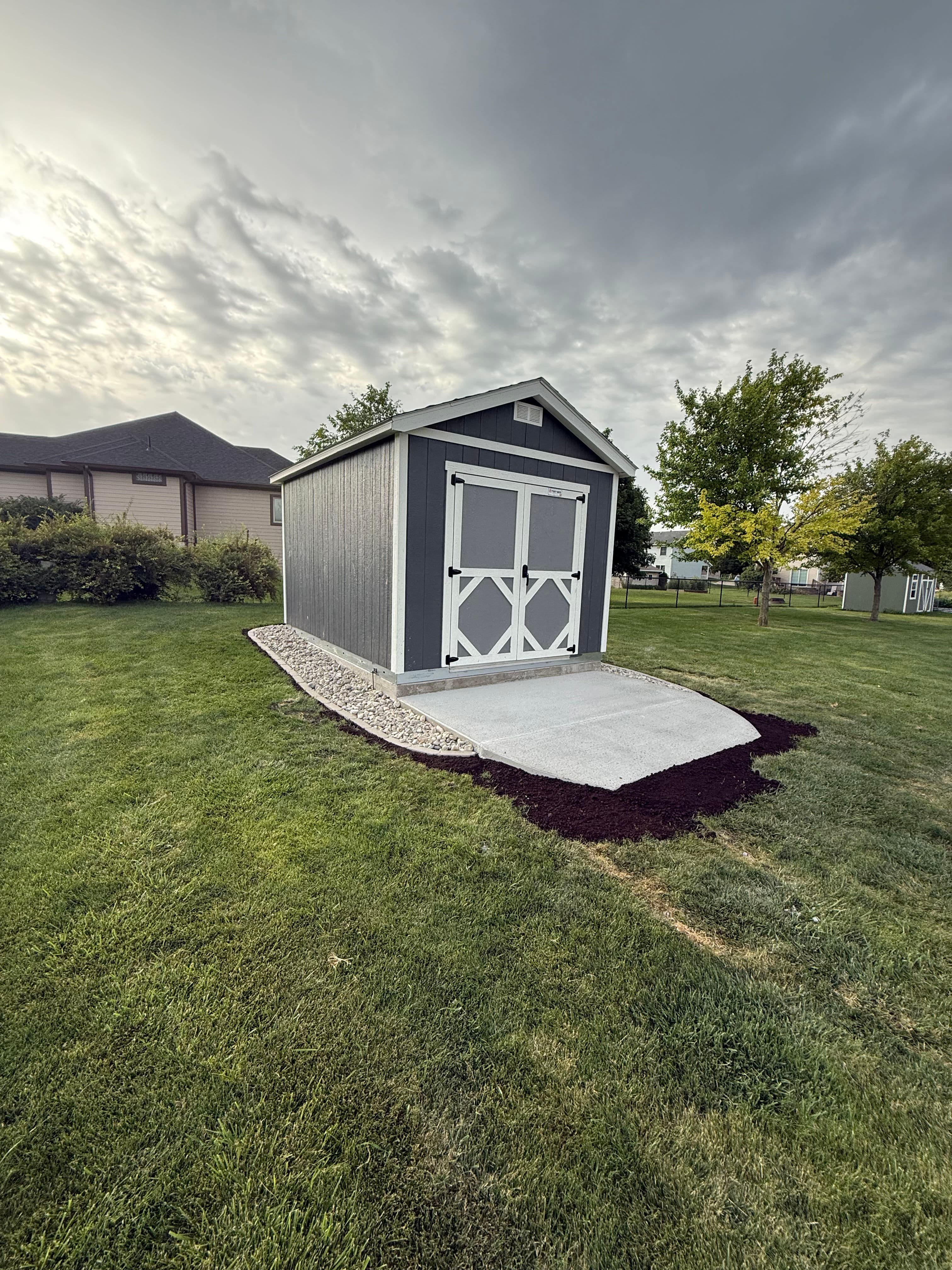 Project Concrete Ramp and Rock Bed Cleanup Around a Backyard Shed image